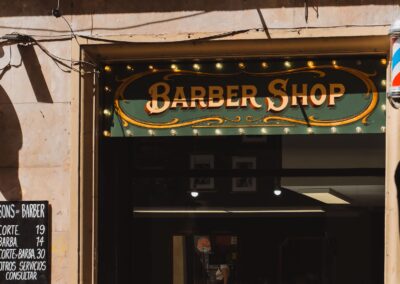 A vintage-style barber shop entrance in Barcelona, featuring classic signage and decor.